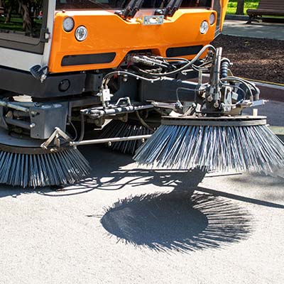 sweeper truck picking up trash with parking lots daily cleaning