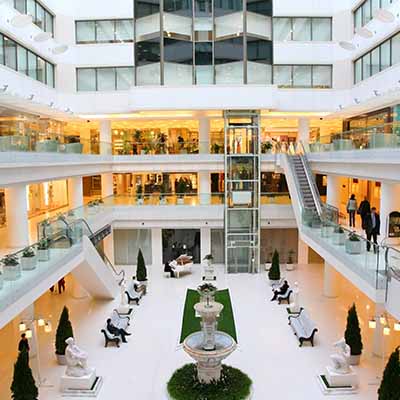 People walking around in large indoor mall serviced by CAM property services