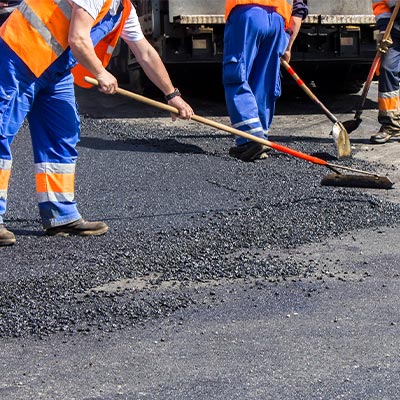 Workers Repairing Pavement Damage
